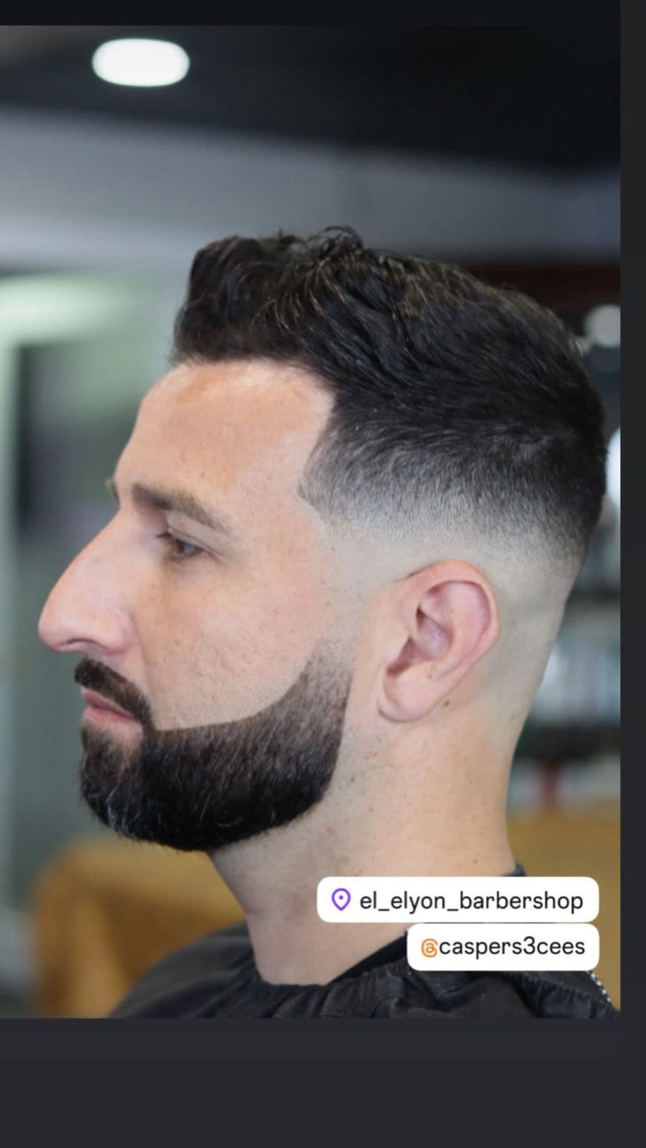 Textured quiff with a high skin fade and beard line-up.