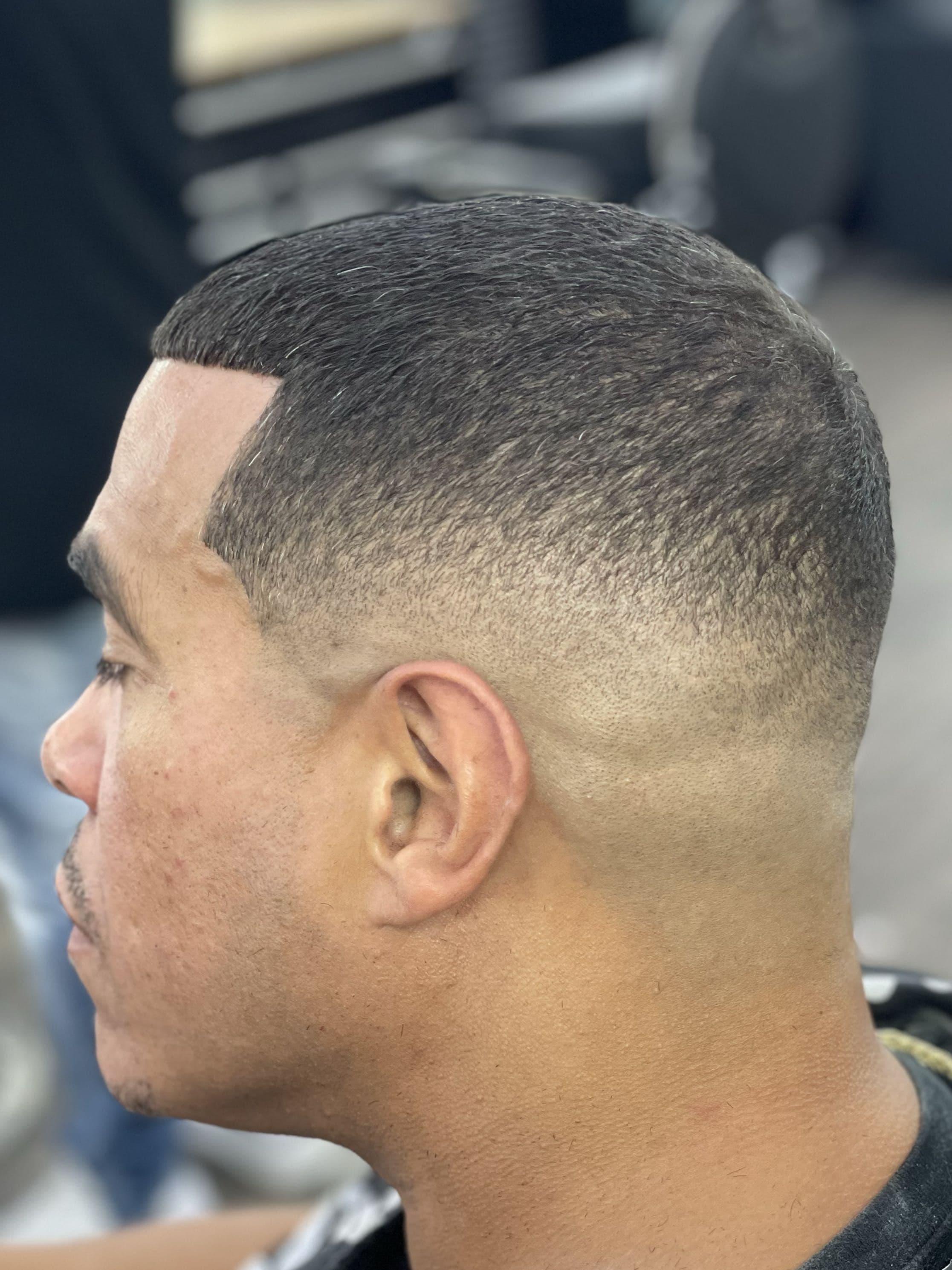 #1-#2 buzz on top with a low bald fade and crisp edge-up.