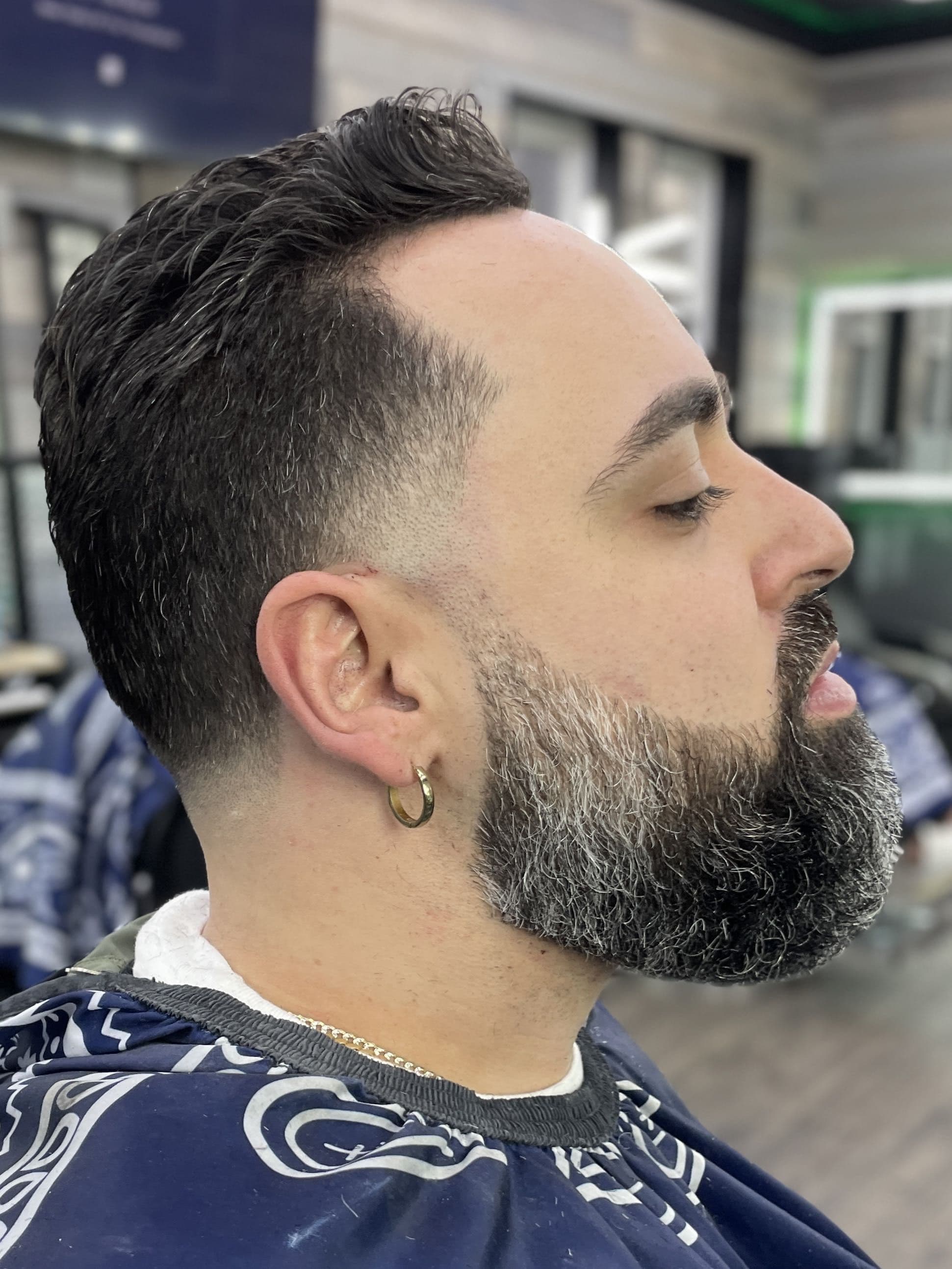Classic scissor cut with a low taper fade and full beard shape-up.