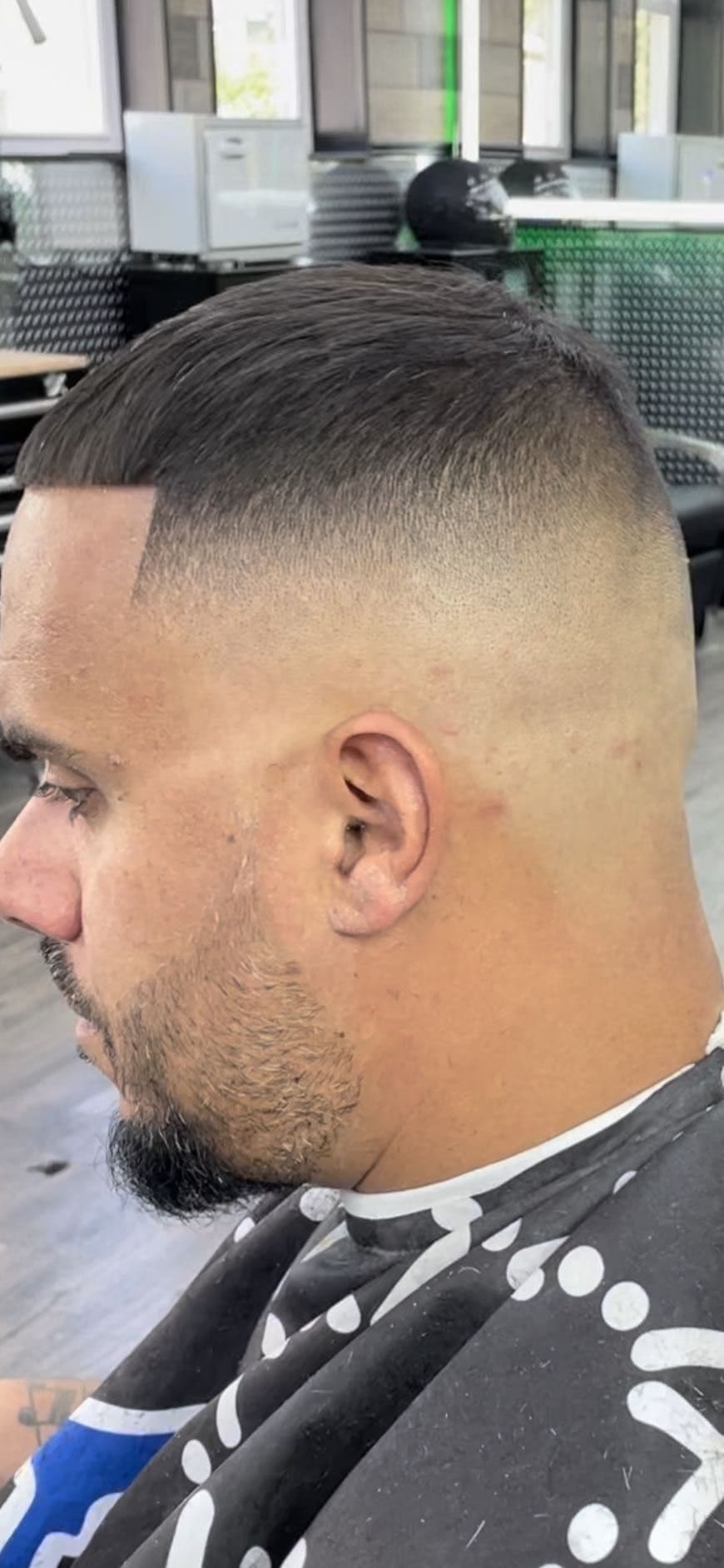 High skin fade with a short cropped top and sharp line-up.