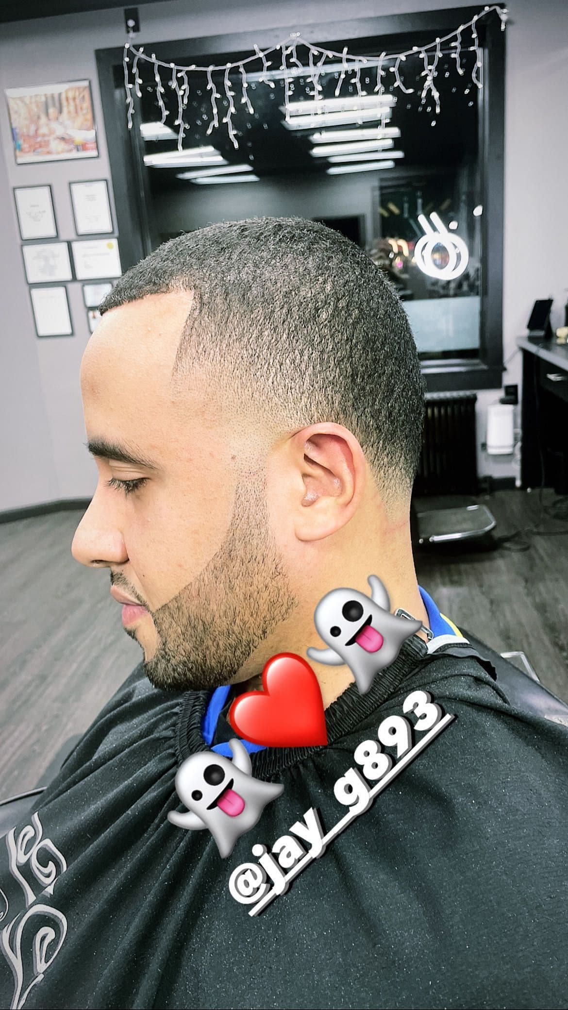 Low taper fade with even buzz, crisp edge-up, and blended beard.