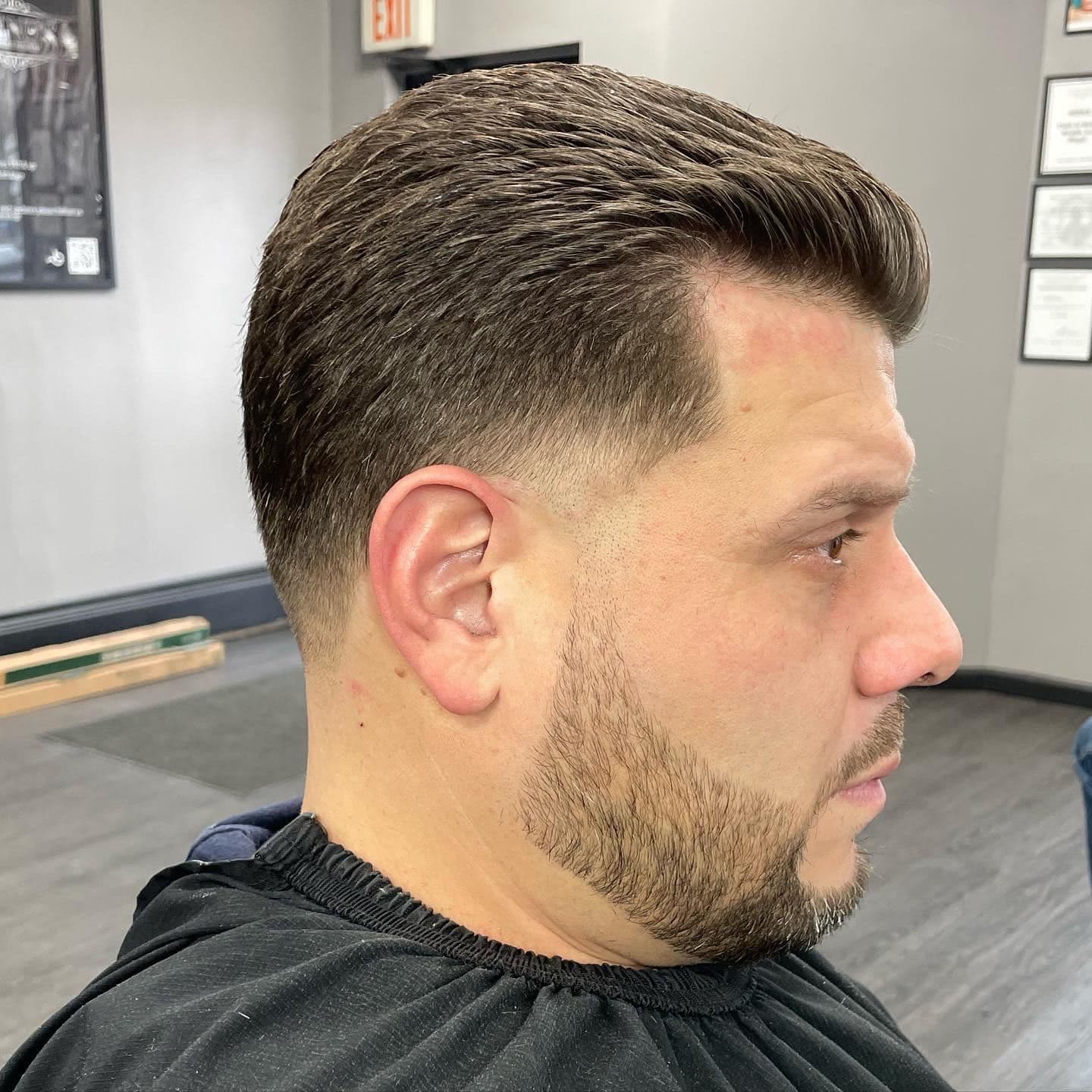 Classic comb-over with a low taper fade and natural side part.